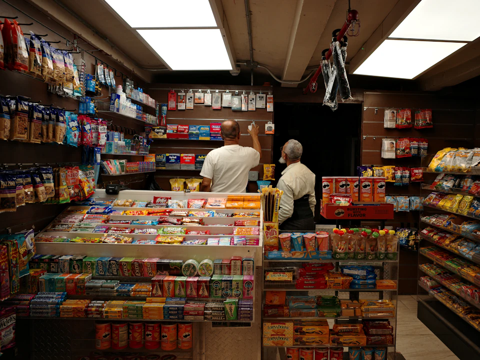 The chilled and snack aisles of a brightly lit convenience store.