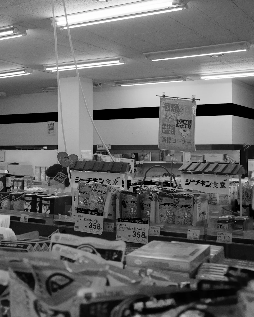 The interior of a small shop, stocked and lit.